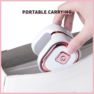 Close-up of portable mini nail lamp in rose gold and white being placed in a handbag
