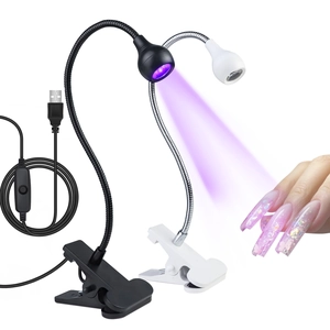 Macro shot of flexible gooseneck UV LED nail lamp with metal clip and USB controller