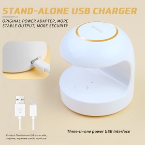 Close-up of portable mini LED nail lamp with USB charging port and power cable details