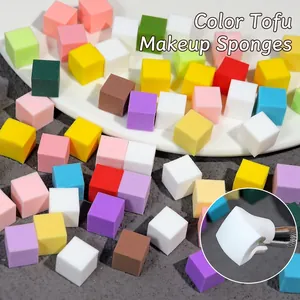 Mini macaron nail art sponges for ombre gradients and blush effects on a display tray