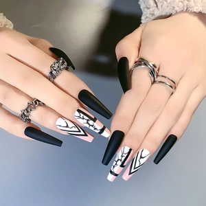 Long coffin press on nails featuring matte black and marble designs on model hand