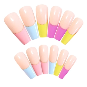 Rainbow French tip coffin fake nails with gold glitter outlines on a white background