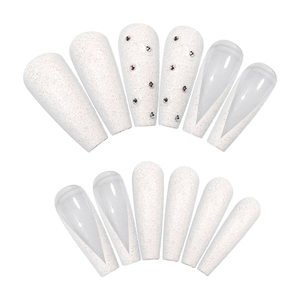 Extra long ballet nails in glitter white with V-shaped French design and rhinestones