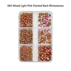 Close-up of pink and champagne pointed glass rhinestones in a 6-grid nail art box