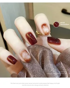 Close-up of glossy vermilion red gel polish with marble texture accent on square nails