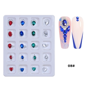 Detail of assorted crystal nail gems in metal settings with colorful manicure examples