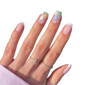 Press-on nails with colorful 3D flowers and classic French white tips on pink base