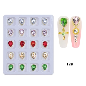 Detailed view of colorful teardrop nail crystals with gold frames in 20-grid tray