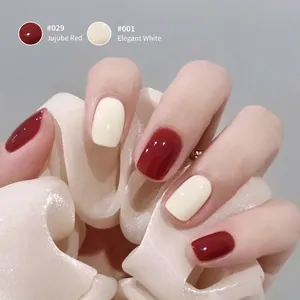 Glossy gel nail polish in Jujube Red and Elegant White finish for professional manicure