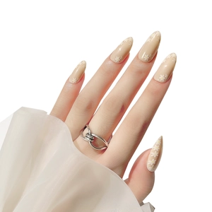 Elegant black glitter flame press-on nails with daisy patterns and silver knot ring