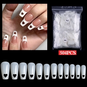 Detailed view of 504pcs white heart cutout French press-on nails in long coffin shape