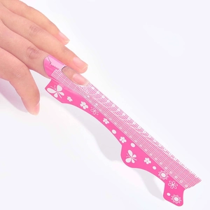 Detailed view of pink butterfly nail extension forms with precise numerical scales