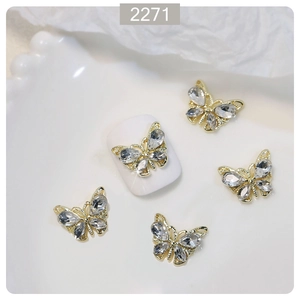 Macro detail of 3D crystal butterfly nail charms with gold alloy base for DIY nail art