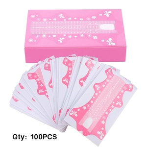 Close-up of 100pcs pink flower nail extension forms set with grid scale lines