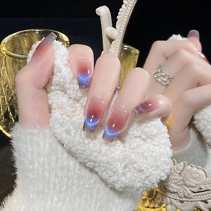 Cat eye press-on nails with red-brown gradient and blue magnetic shimmer in coffin shape