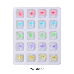 Close-up of 20pcs 3D resin butterfly nail art charms in 5 colors on white tray