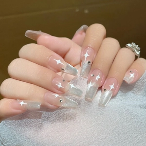 Close-up of silver cat eye gradient coffin nails with white star and rhinestone detail