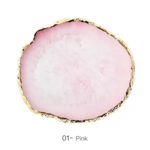 Macro detail of pink resin agate nail palette with irregular gold leaf decorative edges