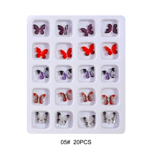 Macro view of 3D resin butterfly nail charms set with colorful aurora artistic patterns