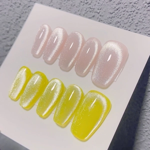 Macro shot of long coffin fake nails with pink and yellow cat-eye shimmer effect