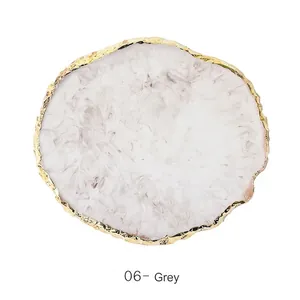 Close-up of grey marble resin tray with gold irregular edge for nail art display