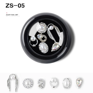 Macro view of ZS-05 alloy nail art kit with silver charms, pearls and rhinestones