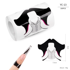 Detailed scale view of butterfly-shaped nail extension forms for professional manicures