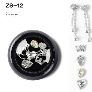 Macro view of alloy nail art rhinestones with silver crowns and hearts in a black storage box