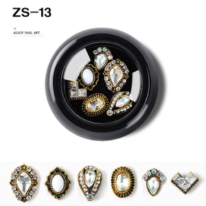 Close-up of alloy nail art rhinestones in various shapes with a black storage case