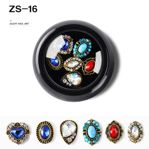 Detailed view of vintage alloy nail art charms with colorful rhinestones in a round black box