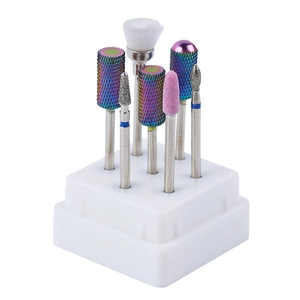 Detailed view of 7 professional rainbow carbide nail drill bits in a white storage base