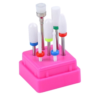 Set of 7 ceramic and tungsten nail drill bits organized in a rose pink storage base