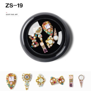 Macro detail of alloy nail art charms with colorful rhinestones in a display box