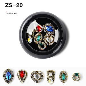 Detail of vintage gold alloy nail art charms with colorful gemstones and rhinestones