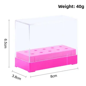 Macro detail of a clear acrylic nail drill bit storage box with 10 holes and pink base