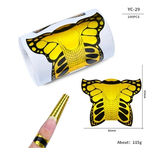 Macro detail of butterfly shaped nail extension guides with scale marks and sizing labels