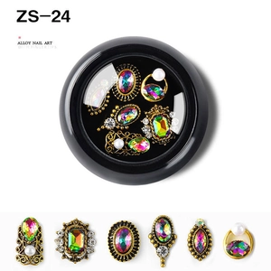 Close-up of vintage gold alloy nail art charms with iridescent rhinestones and pearls
