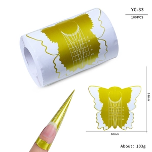 Macro detail of butterfly gold nail extension stickers with scale 1-5 and S-XXL sizes