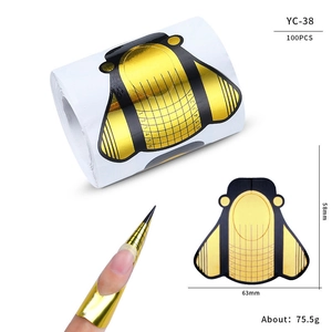 Macro detail of bee-shaped nail extension tips with scale lines for precise sculpting