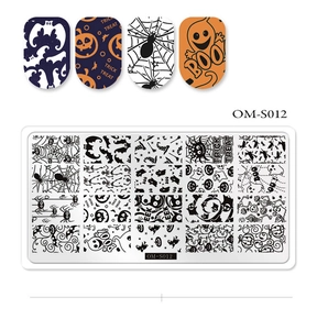 Macro shot of Halloween nail art stamping plate with spider web and pumpkin patterns