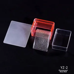 Detail view of transparent nail art stamper kits with scraper components in fluorescent rose red