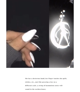 Detailed view of reflective nail art stickers showing moon and girl silhouette pattern