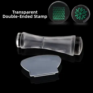 Dual-ended clear silicone nail art stamper set with scraper tool on black background