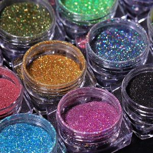 Macro shot of colorful high-shine nail art glitter powder in small round containers