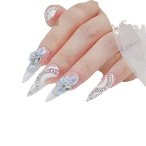 3D blue resin flower nail charms with pearls and rhinestones on long stiletto nails
