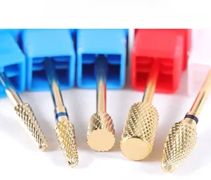 Macro detail of gold-coated diamond nail drill bits for cuticle removal and manicures