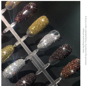 Macro shot of glittery caviar nail powder on samples in gold, silver and purple hues