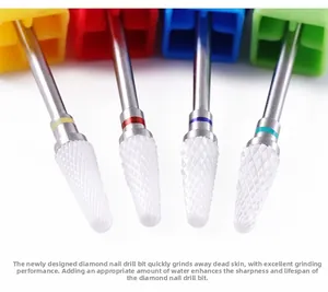 Detailed macro view of 4-piece ceramic nail drill bits with color-coded safety bands