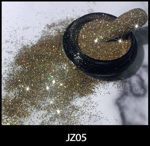 Macro shot of sparkling gold-brown nail glitter powder JZ05 with shimmering finish