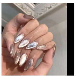 Close-up of almond-shaped cat eye nails with champagne and mocha metallic luster